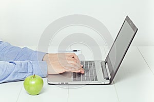 Man working on laptop. healthy eating at office.