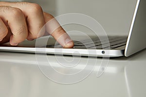 A man working on a laptop, his hands close up