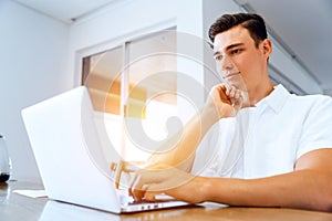 Man working on laptop at home