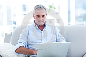 Man working on laptop at home