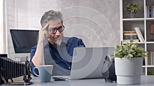 Man working with laptop at home office