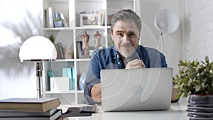 Man working with laptop at home office