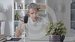 Man working with laptop at home office