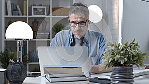 Man working with laptop at home office