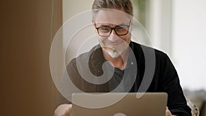 Man working with laptop at home outdoor on terrace