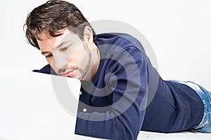 Man working on laptop while laying on the floor