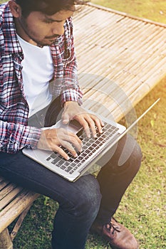 Man working on laptop. Nature background.