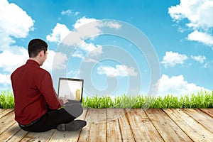 Man working with laptop sit on the floor