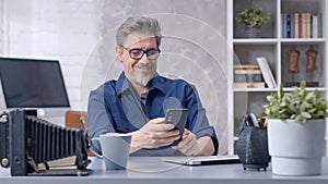 Man working with laptop and smart phone at home office