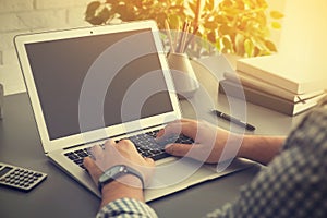 Man working with laptop at table indoors. Space for design