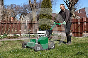 Man working with Lawn Aerator photo