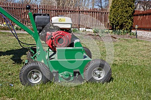 Man working with Lawn Aerator photo