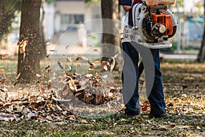 Man working with leaf blower,Man operating a heavy duty leaf blower. photo
