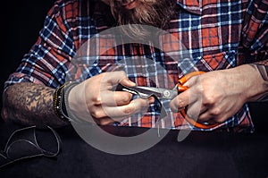 Man working with leather being keen on his buisness