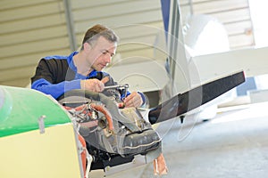 Man working on light aircraft