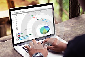 Man working with management project dashboard on laptop / computer