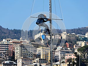 Man working on a mast of a ship