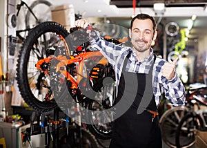 Man working on master mechanic assembling bicycle equipment