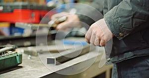 Man Working at Metal Industry - Cutting and Measuring Metal Parts at Workshop