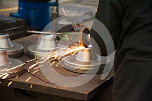 Man working the metal producing sparks