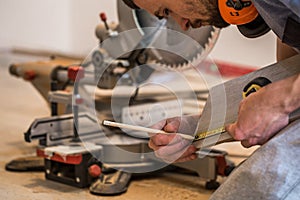 A man working with a miter saw