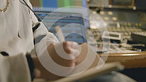 Man working at music recording studio, making notes