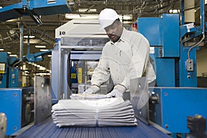 Man Working On Newspaper Production Line