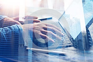 Man working at office.Closeup view of male hands typing on electronic tablet keyboard-dock station.Double exposure