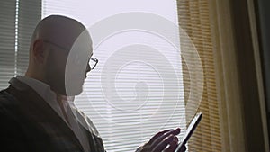 Man working in office with tablet. Business people developing a business project and analyzing market data information