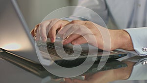 Man working at office, typing e-mail on laptop, startup business