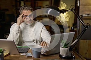 Man working online with computer in home office