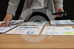 man working organizing plan with smart phone. businessman analyzing document at workplace