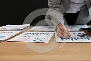 man working organizing plan with smart phone. businessman analyzing document at workplace