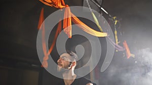 Man working out with kettlebell, dark foggy gym