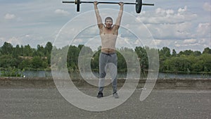 Man working out outdoors with barbell
