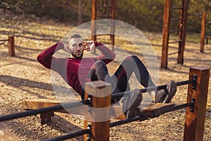 Man doing crunches while working out outdoors