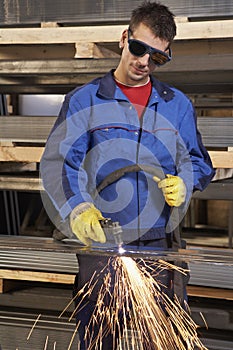 Man working with plasma cutter
