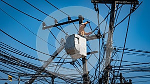 Man working with power line pole