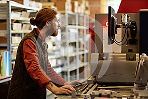 Man Working at Print Factory And Using Machines