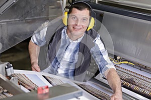 man working in printing factory printing press