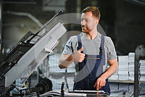 Man working in printing house with paper and paints