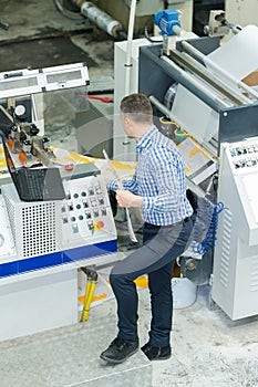 man working with printing machine