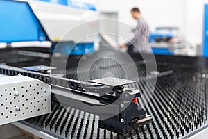 Man working at programmable CNC machine