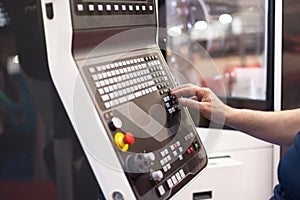 Man working at programmable machine photo