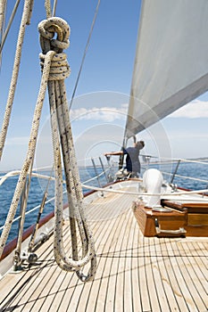 Man working on prow of yacht