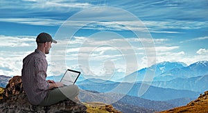 Man working remotely outdoors with laptop