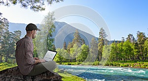 Man working remotely outdoors with laptop