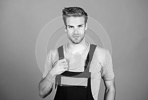 Man working in repair shop. man builder in work clothes. man build house. skilled architect repair. worker purple