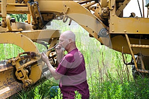 Man working on road equipment