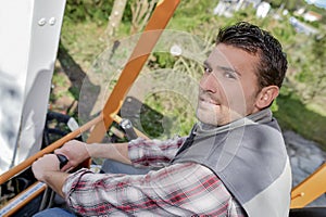 Man working sat in cab digger